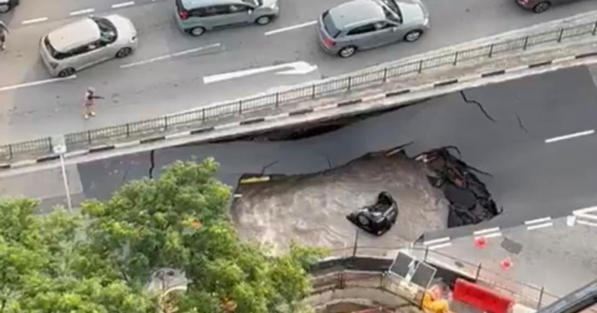 Sinkhole swallows car in Singapore, driver rescued