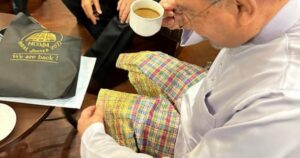 Anwar makes light of wearing sampin upside down at a meeting