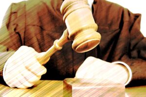 Govt department director claims trial to power abuse charge