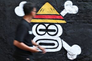 Indonesian artists, students unfurl manga pirate sign as protest symbol