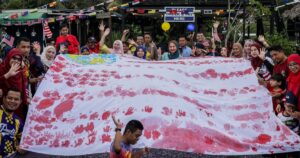 Students with disabilities craft Jalur Gemilang with handprints to mark national month