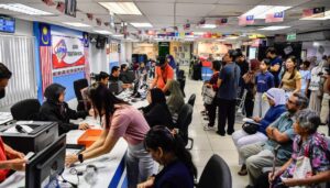 Crowds flock to UTC NRD counters to replace damaged, old MyKad