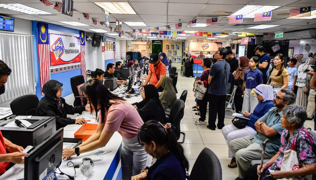 Crowds flock to UTC NRD counters to replace damaged, old MyKad