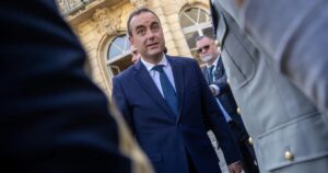 France’s new PM courts the left a day after ratings downgrade