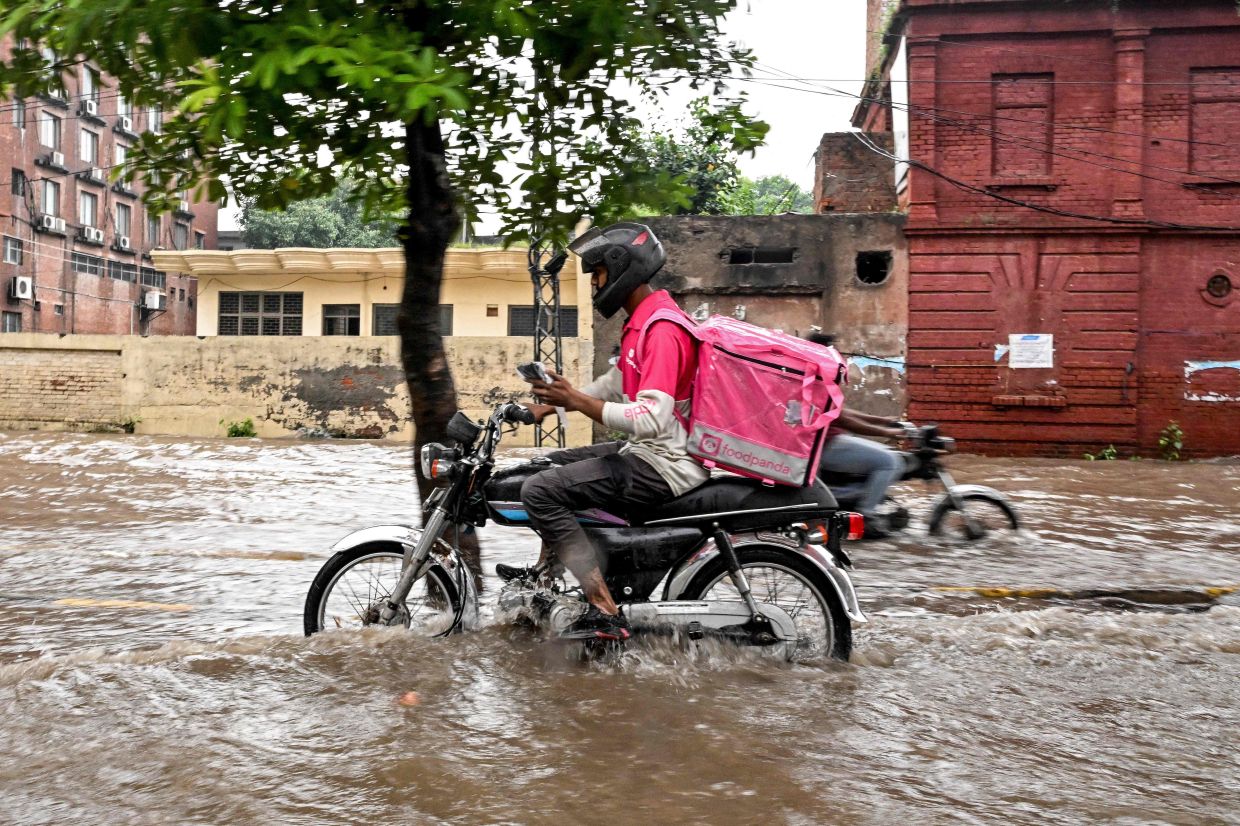 No pause for food delivery riders during Pakistan's monsoon
