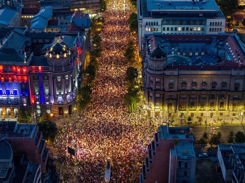 Tens of thousands march in Serbia's capital, demand snap vote