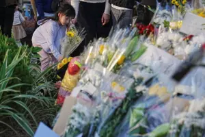 Hong Kong mourners gather at deadly fire site as Beijing issues protest warning
