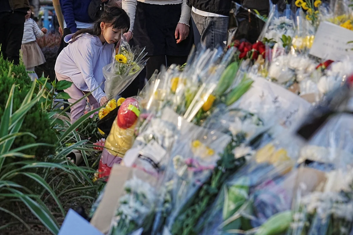 Hong Kong mourners gather at deadly fire site as Beijing issues protest warning