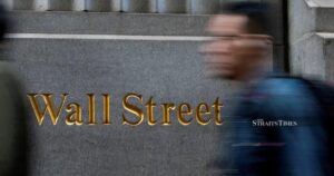 Wall St falls as bank CEOs warn of possible pullback, sparking tech bubble jitters